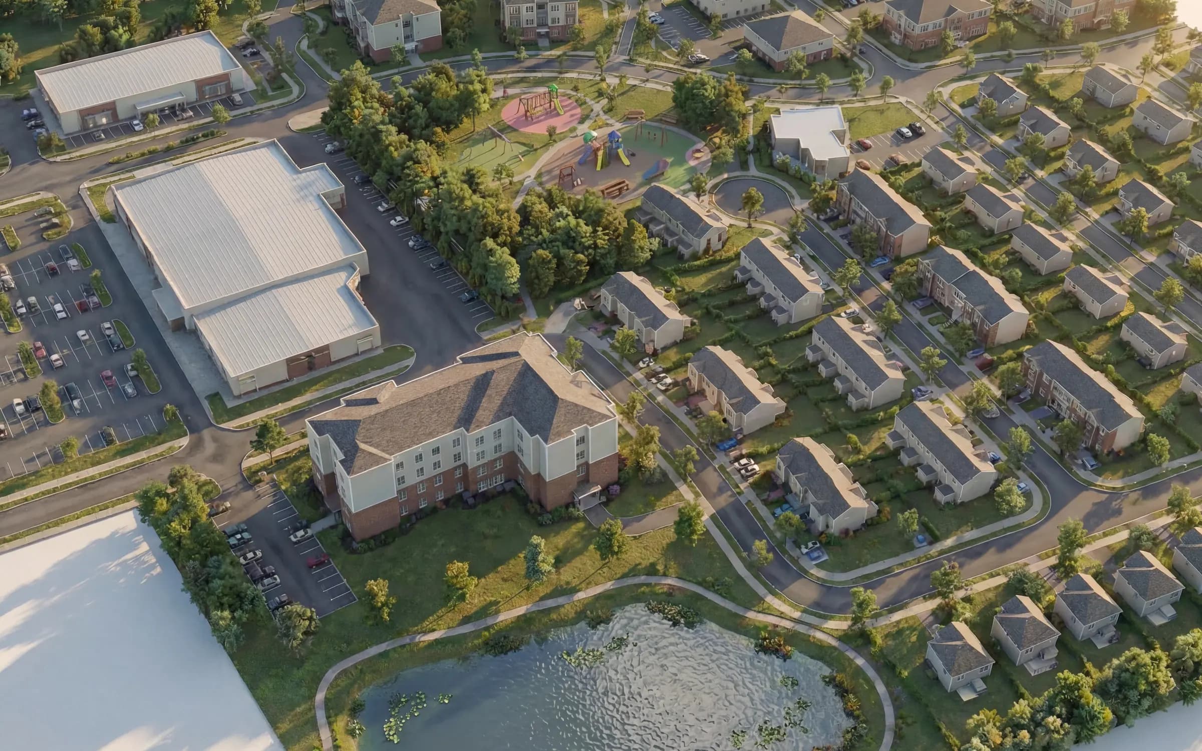 Vue aérienne conceptuelle du quartier Réserve Étoilée à East Angus : maisons de ville, jumelées, immeuble multirésidentiel, parc et bassin.